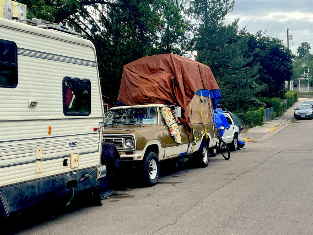 Truck belonging to the owner of the RV acts as a mobile storage unit that has been parked at Hawthorne and Pine for over a year.